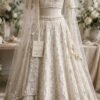 Ivory pearl white nikkah lehenga with sweetheart-neck choli, pearl work and sheer net dupatta by NoorNoorani