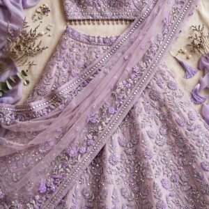 Pastel lavender organza engagement lehenga with thread embroidery, mirror work and puff-sleeve choli by NoorNoorani