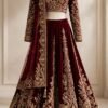 Royal maroon velvet bridal lehenga with full-sleeve choli and heavy gold zardozi and dabka work by NoorNoorani