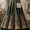 Emerald green velvet bridal lehenga with antique gold zari work and three-layer can-can by NoorNoorani